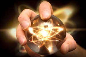 Hand holding an atom